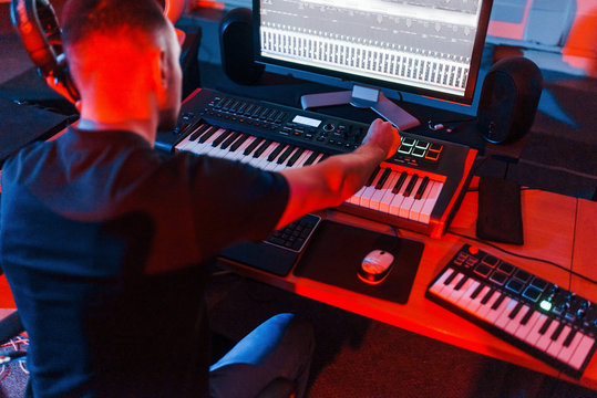Professional sound engineer working and mixing music indoors in the studio