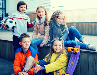 Fototapeta na wymiar group of children sitting on wooden scaffolding schoolyard