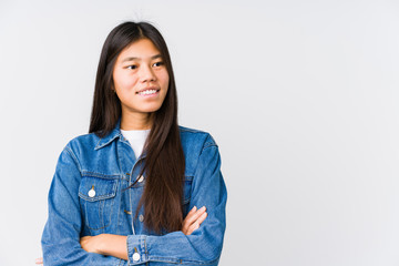 Young asian woman smiling confident with crossed arms.