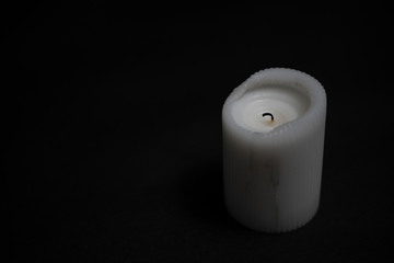 Light extinct candle on a black background.