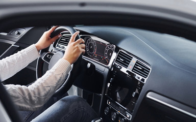 Particle view of man in formal wear that riding brand new car