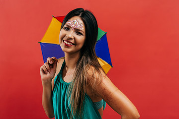 Young woman celebrating the Brazilian carnival party with Frevo umbrella