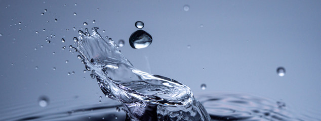 Water drops collision on a blue background. Abstract clear nature background