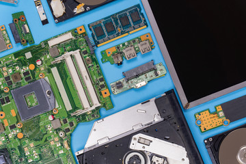 Parts of a modern computer. The insides of a laptop on a blue background, flat lay composition