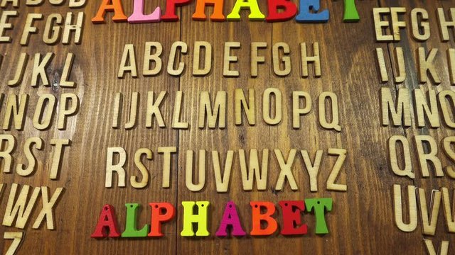 Track forwards and then backwards over the alphabet arranged in wooden letters.