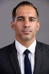 Face of mature handsome Persian businessman in suit