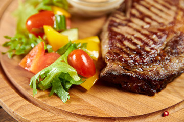 grilled steak with vegetables on plate