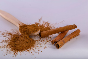 cinnamon sticks and powder on white background