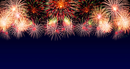 Abstract multicolor firework on blue background with free space for text. Ideal for New Year,Celebration, anniversary concept.