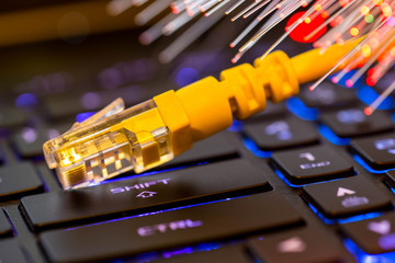 Yellow internet switch on gaming laptops RGB  keyboard, glowing optical fibres, image for...