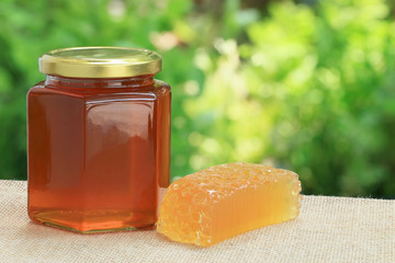 Honey from nature pollen flower in glass bottle with soap.