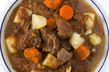 Irish beef stew with carrots and potatoes isolated on white background. Close up	