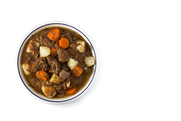 Irish beef stew with carrots and potatoes isolated on white background. Top view. Copy space	