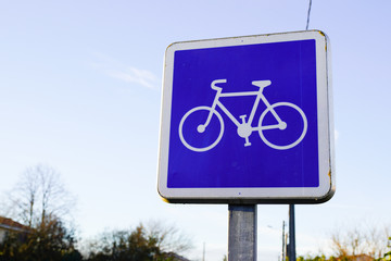road sign of bicycle lane in city blue information