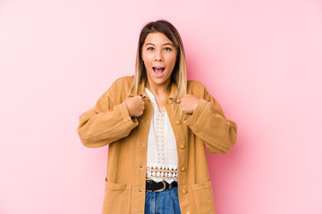 young caucasian woman posing isolated surprised pointing with finger, smiling broadly.