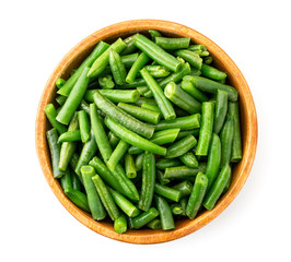 Slices of green beans in a plate on a white background, top view. Isolated
