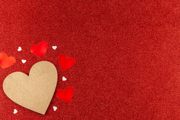 Fototapeta premium Valentine Day Composition: Gold Wooden Heart with Small Hearts Around on Red Glitter Background. Concept of Love, Birthday, Happy Valentine's Day, Merry Christmas. Top View, Copy Space