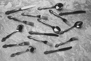 many spoons and forks on the table
