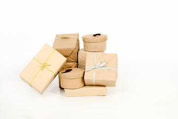 Obraz premium Varios regalos, paquetes envueltos en papel kraft marrón con lazos aislados sobre fondo blanco