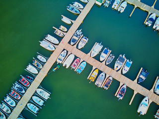 Obraz premium Top down view of colorful boats near wooden berth in the countryside of Finland