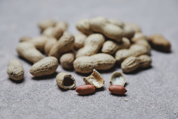 a lot of unpeeled peanuts on the table