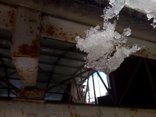 Icicles of a strange surreal shape hang from the roof.