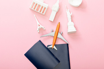 top view of passports near toy plane and figurines from countries on pink © LIGHTFIELD STUDIOS