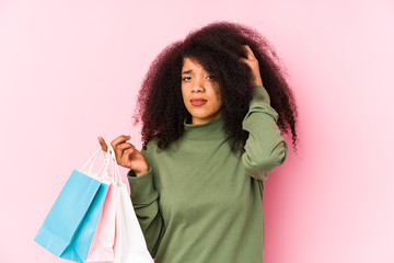 Young afro woman shopping isolated Young afro woman buying isolaYoung afro woman holding a roses isolated being shocked, she has remembered important meeting.< mixto >