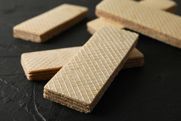 Sweet wafer biscuits on black background, close up