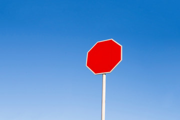 A red forbidding sign against a blue sky. Warning.