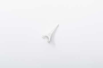 Obraz premium top view of small eiffel tower statuette isolated on white