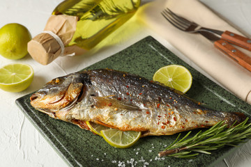 Square plate with Dorado on garnished white background, close up