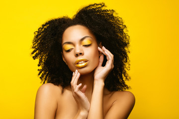 Yellow make up. African American Model portrait . Brunette young woman with afro hair style,creative make-up lips and eyeshadows on  background. Summer beauty concept