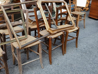 Flea market. Old wooden chairs and frames.