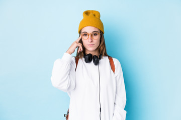 Young student woman isolated pointing temple with finger, thinking, focused on a task.