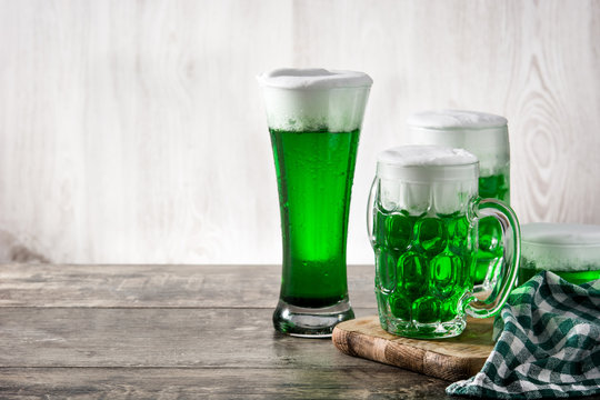 Traditional St Patrick's Day green beers on wooden table. Copy space
