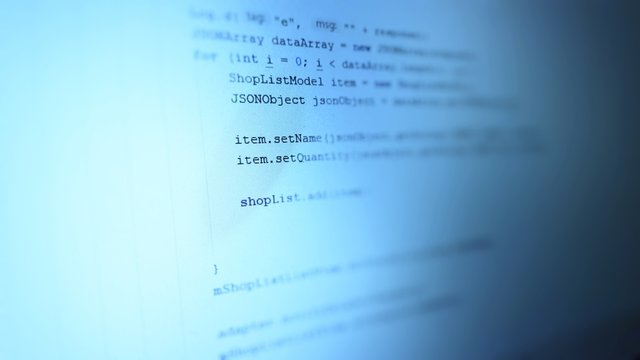  Android mobile development. Application source code on notebook blue screen background.  Software developer programming code on computer. Abstract computer script source code.