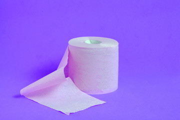 Roll of toilet paper on a lilac background.
