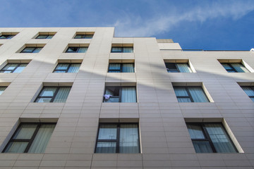 Fragment of  facade with windows of a building seen from below in Madrid. Spain