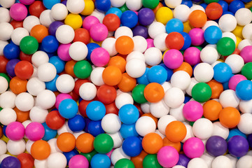 Fototapeta na wymiar texture of multi-colored plastic balls for the background. For children`s rooms, playgrounds. close-up, top view
