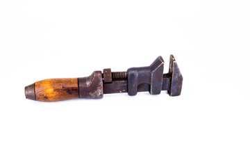 Old rusty plumbers monkey wrench with wooden handle