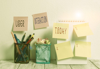 Word writing text User Interaction. Business photo showcasing the conduit between huanalysis and computer interaction 6 Sticky Notes on Wall Open Spiral Notebook 2 Pencil Pots on Work Desk