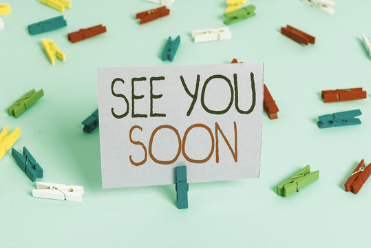 Handwriting text writing See You Soon. Conceptual photo used for saying goodbye to someone and going to meet again soon Colored clothespin papers empty reminder blue floor background office pin