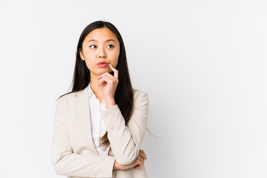 Young business chinese woman isolated looking sideways with doubtful and skeptical expression.