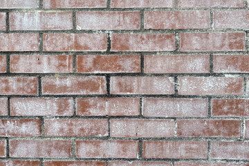 faded white washed red brick wall