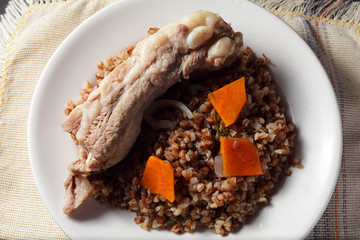 buckwheat porridge with pork ribs on a white plate