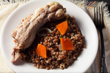 buckwheat porridge with pork ribs on a white plate