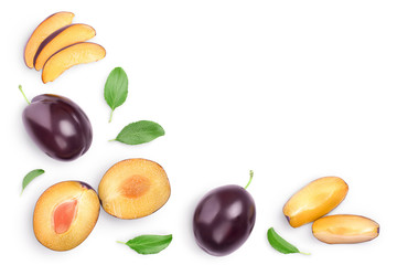 fresh purple plum and half with leaves isolated on white background with clipping path and copy spase for your text. Top view. Flat lay