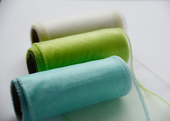 Reels organza ribbon pastel colors white blue green isolated white background. Design concept for...