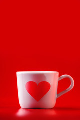 Valentine's day celebration or love template. Cup of tea or coffee with heart on red background. Copy space